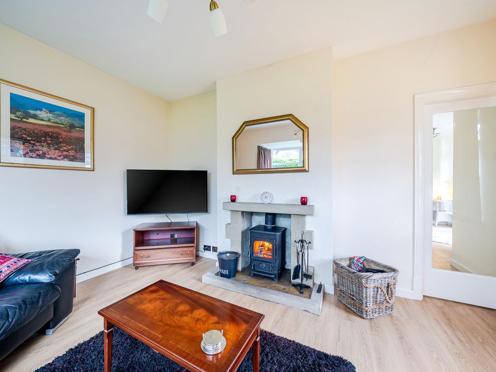 A living room with a television and fireplace at Waltergarth in Horton-In-Ribblesdale
