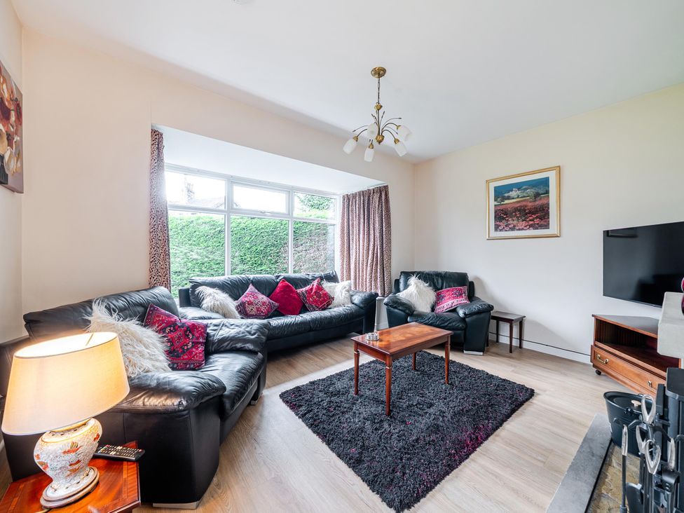 A living room with leather sofas and a coffee table at Waltergarth in Horton-In-Ribblesdale