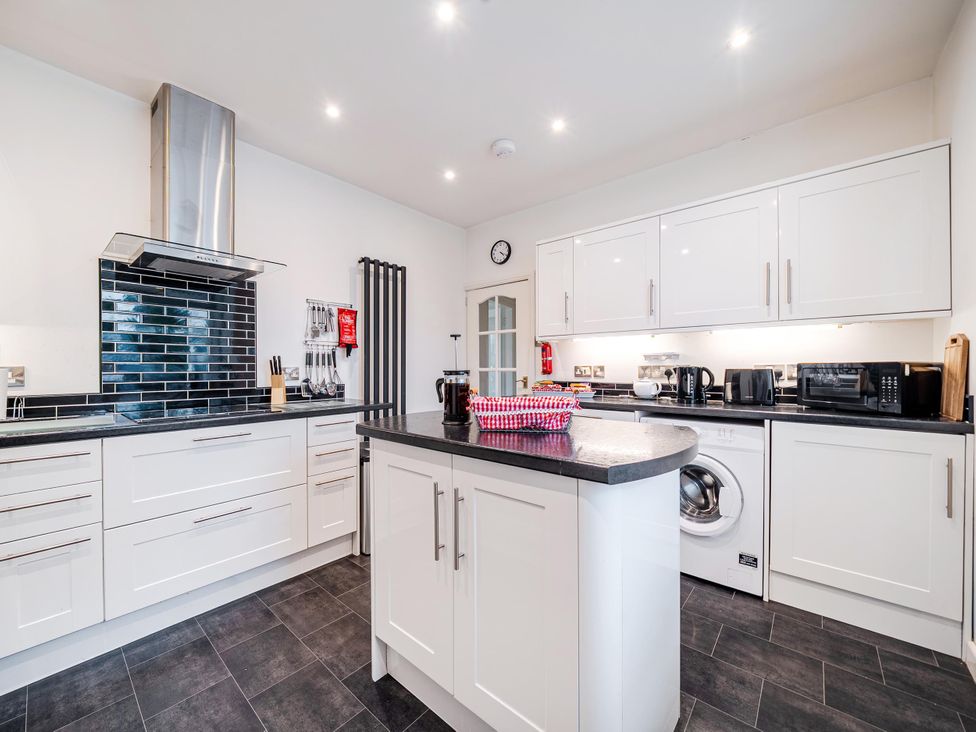 A kitchen with cabinets and appliances at Waltergarth in Horton-In-Ribblesdale