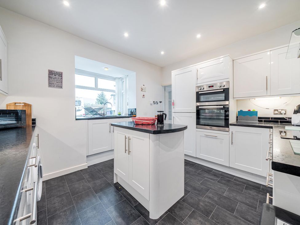 A kitchen with appliances and an island at Waltergarth in Horton-In-Ribblesdale