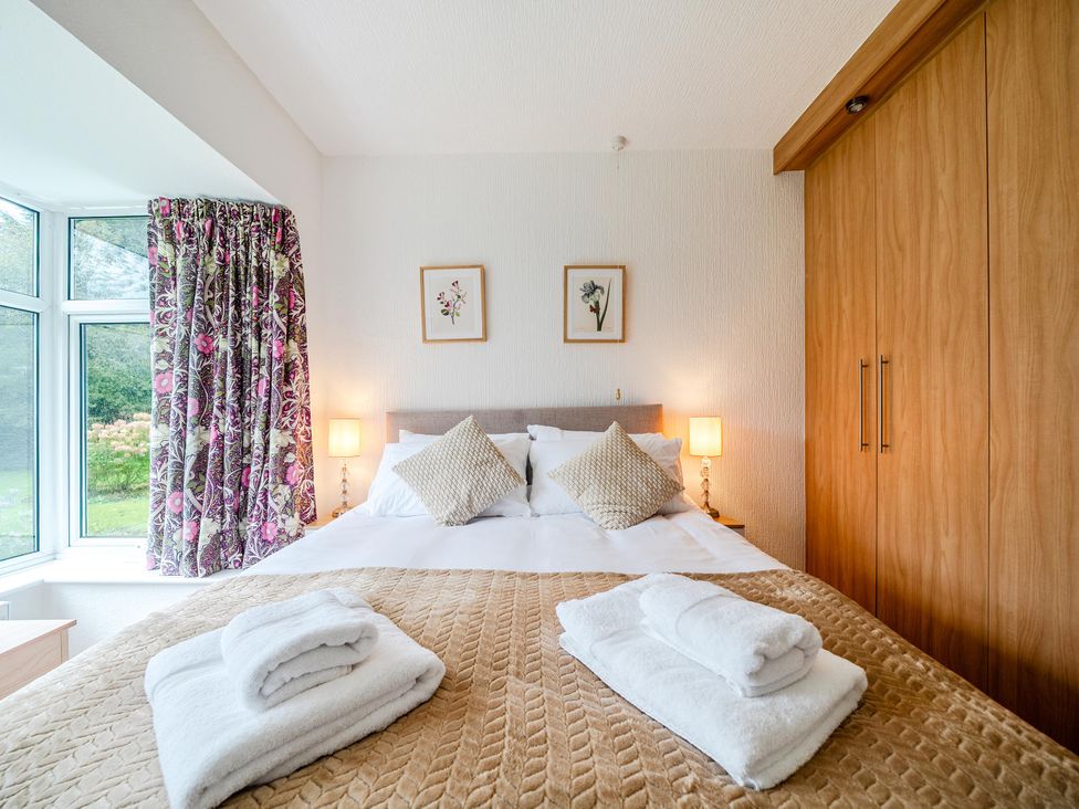A bedroom with a bed and curtains at Waltergarth in Horton-In-Ribblesdale