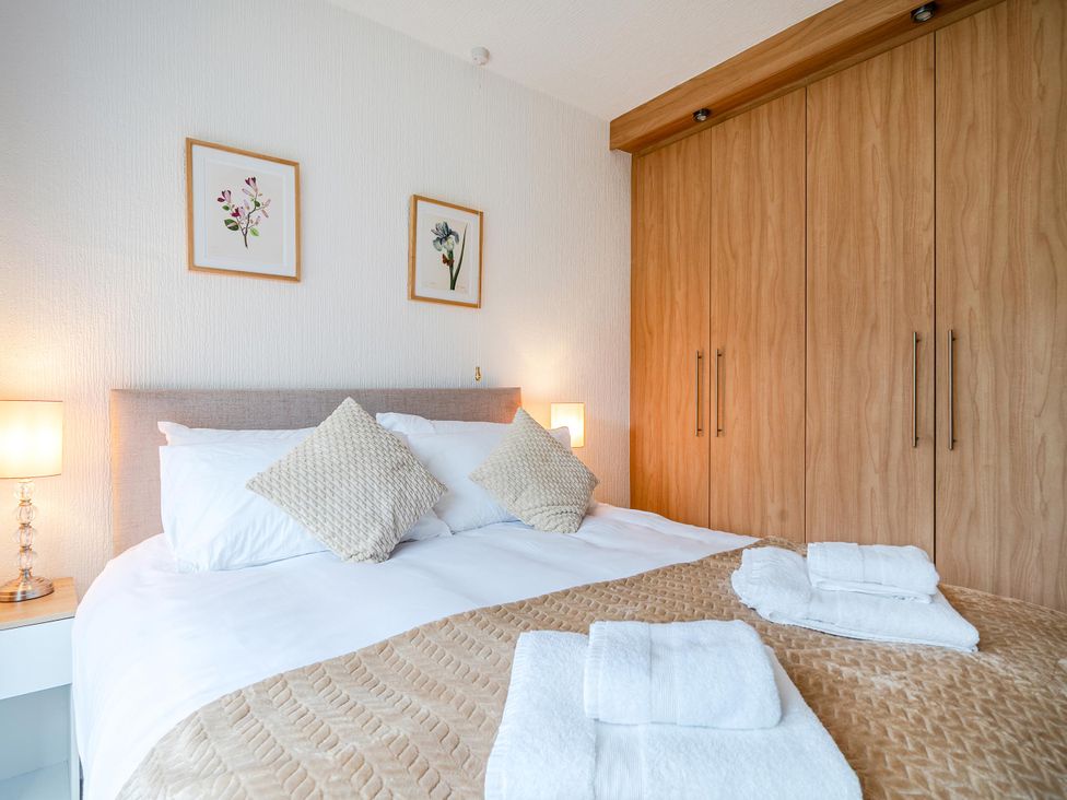 A bedroom with a bed and wardrobe at Waltergarth in Horton-In-Ribblesdale