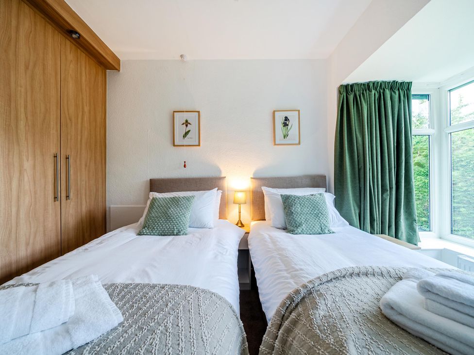 A bedroom with twin beds and a wardrobe at Waltergarth in Horton-In-Ribblesdale
