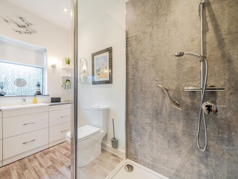 A bathroom with shower, toilet, and vanity unit at Waltergarth Horton-In-Ribblesdale