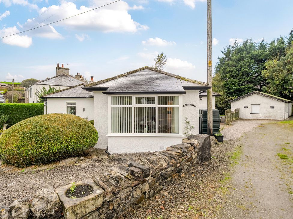 A bungalow with a driveway and landscaping at Waltergarth Horton-In-Ribblesdale