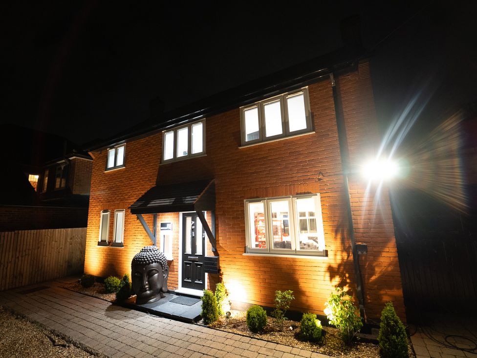 A house with buddha statue and pathway lights at 29 Batchworth Lane Northwood, Hertfordshire