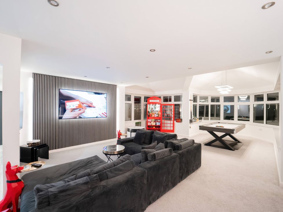 A living room with a pool table and a television at 29 Batchworth Lane Northwood, Hertfordshire
