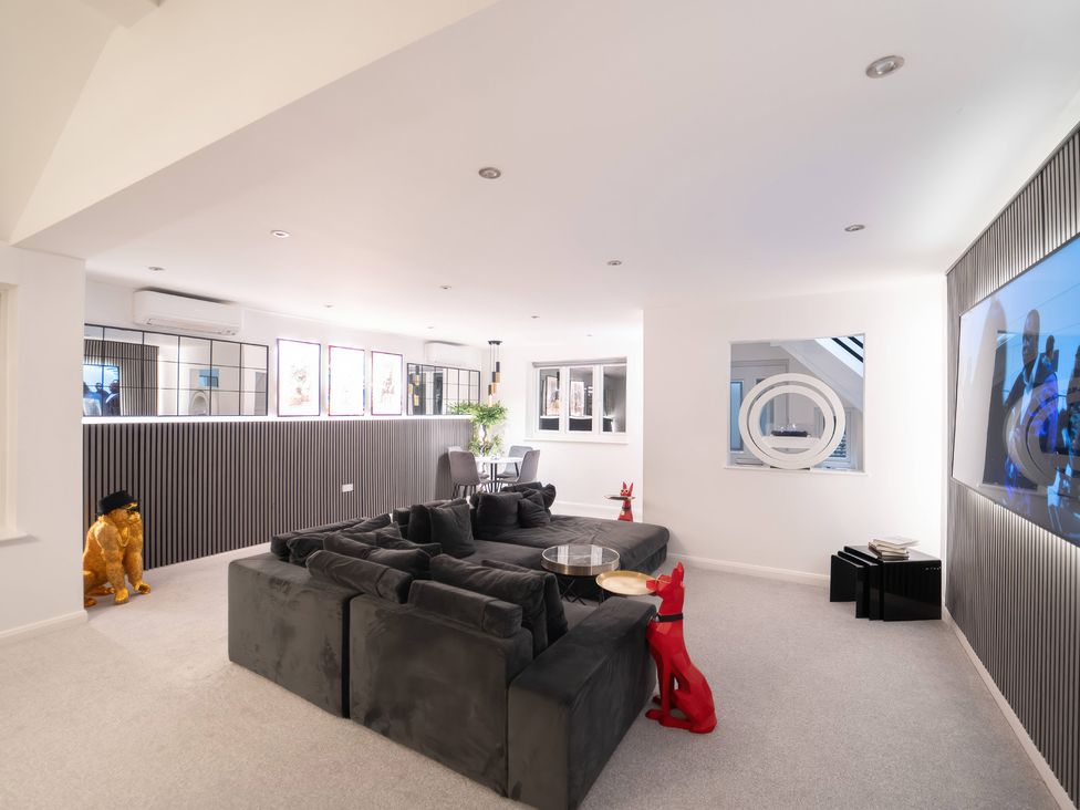 A living room with a sofa and TV at 29 Batchworth Lane Northwood, Hertfordshire