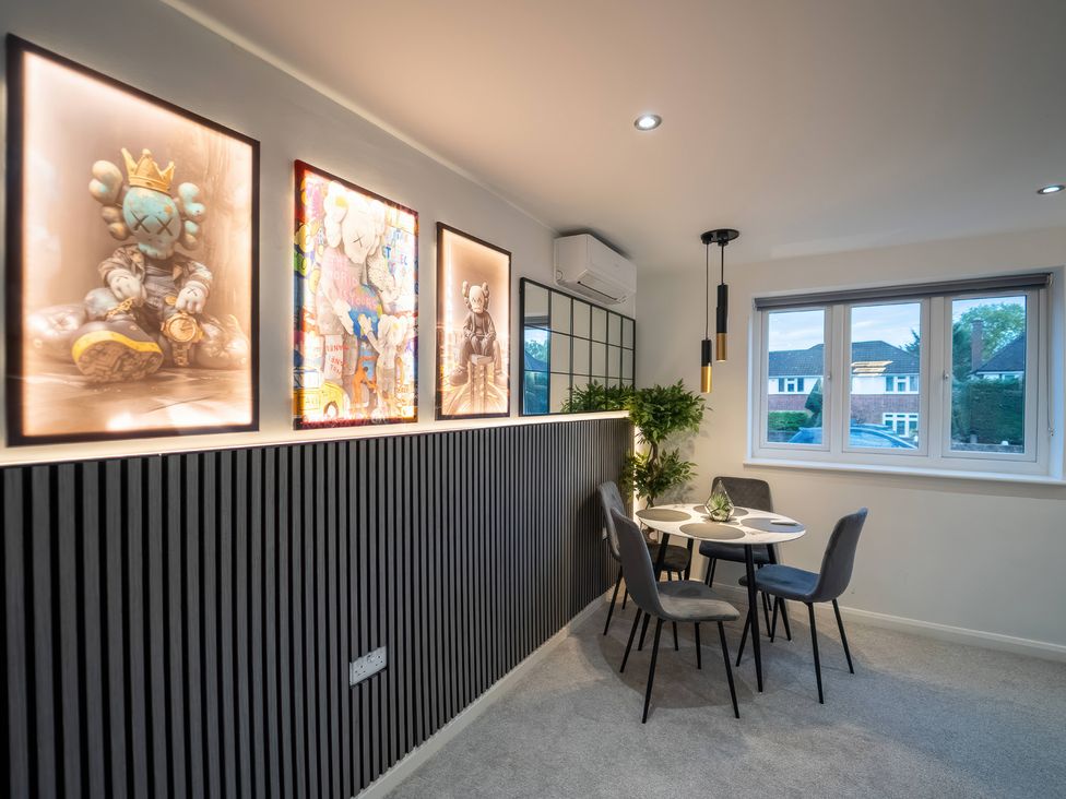 A dining room with a table and chairs at 29 Batchworth Lane, Northwood, Hertfordshire