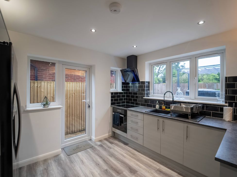 A kitchen with a sink and stove at 29 Batchworth Lane Northwood, Hertfordshire
