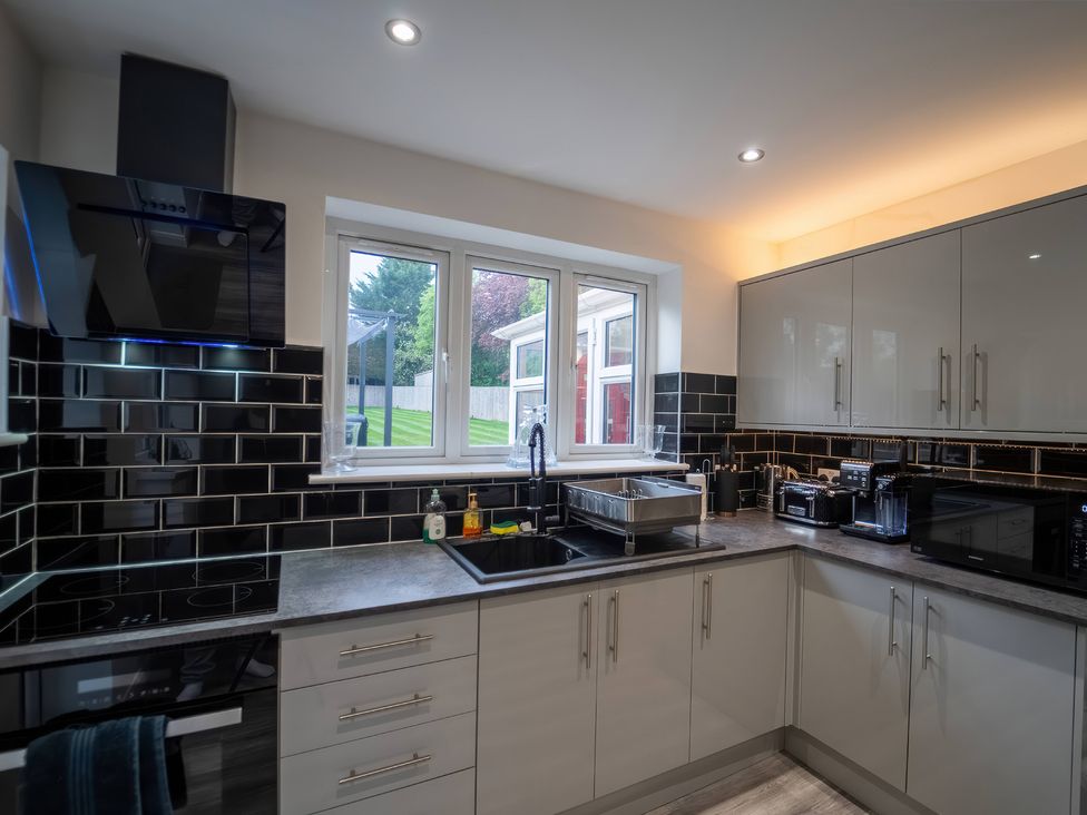 A kitchen with a sink and cabinets at 29 Batchworth Lane Northwood, Hertfordshire