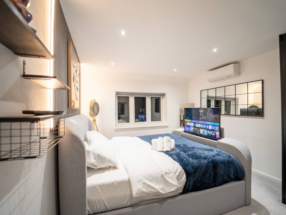 A bedroom with a TV and window at 29 Batchworth Lane Northwood, Hertfordshire