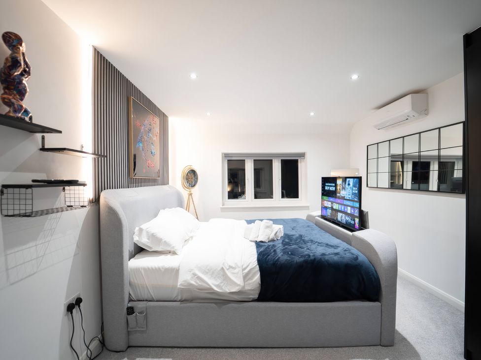 A bedroom with a bed and television at 29 Batchworth Lane in Northwood, Hertfordshire
