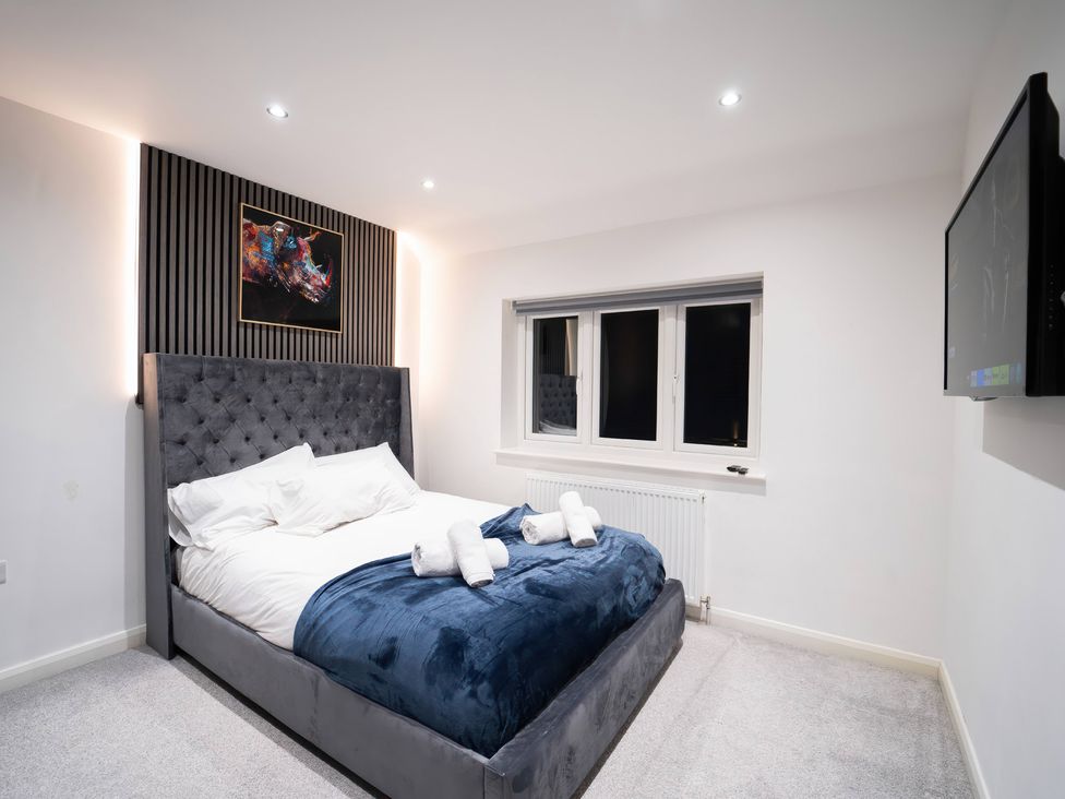 A bedroom with a bed and a television at 29 Batchworth Lane Northwood, Hertfordshire
