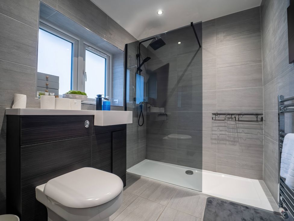 A bathroom featuring a shower and a toilet at 29 Batchworth Lane, Northwood, Hertfordshire