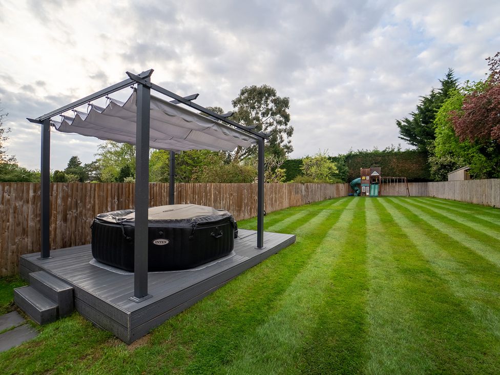 A hot tub under a canopy in the garden at 29 Batchworth Lane Northwood, Hertfordshire
