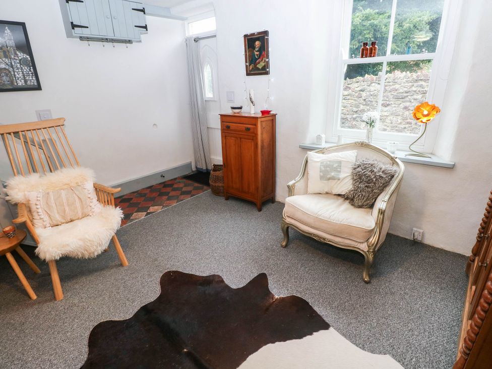 A sitting room with a rocking chair and an armchair at 11 Church Street Narberth