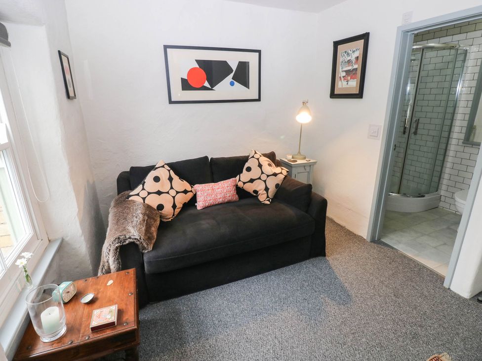 A living room with a sofa and side table at 11 Church Street Narberth
