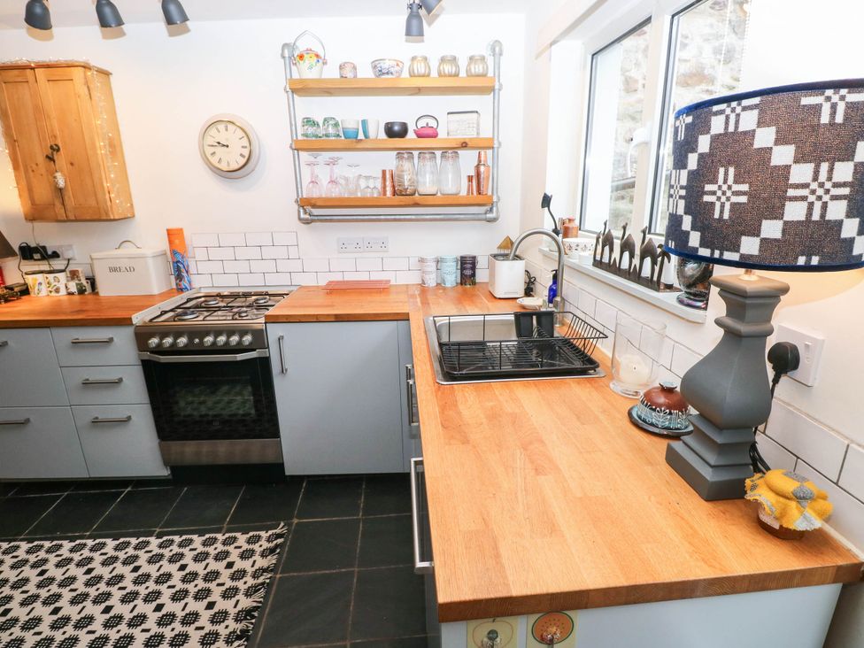 A kitchen with a sink and oven at 11 Church Street in Narberth