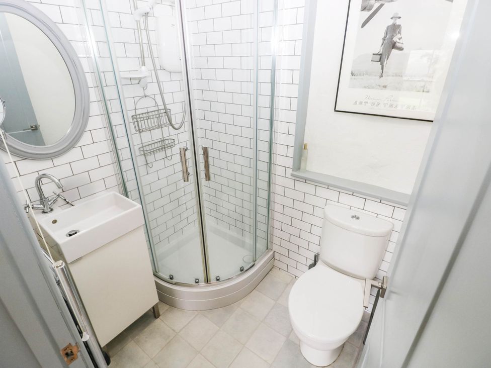 A bathroom with a shower, toilet, and sink at 11 Church Street Narberth