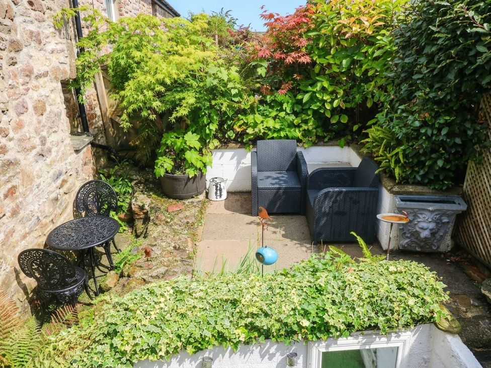 A garden with seating area and plants at 11 Church Street in Narberth