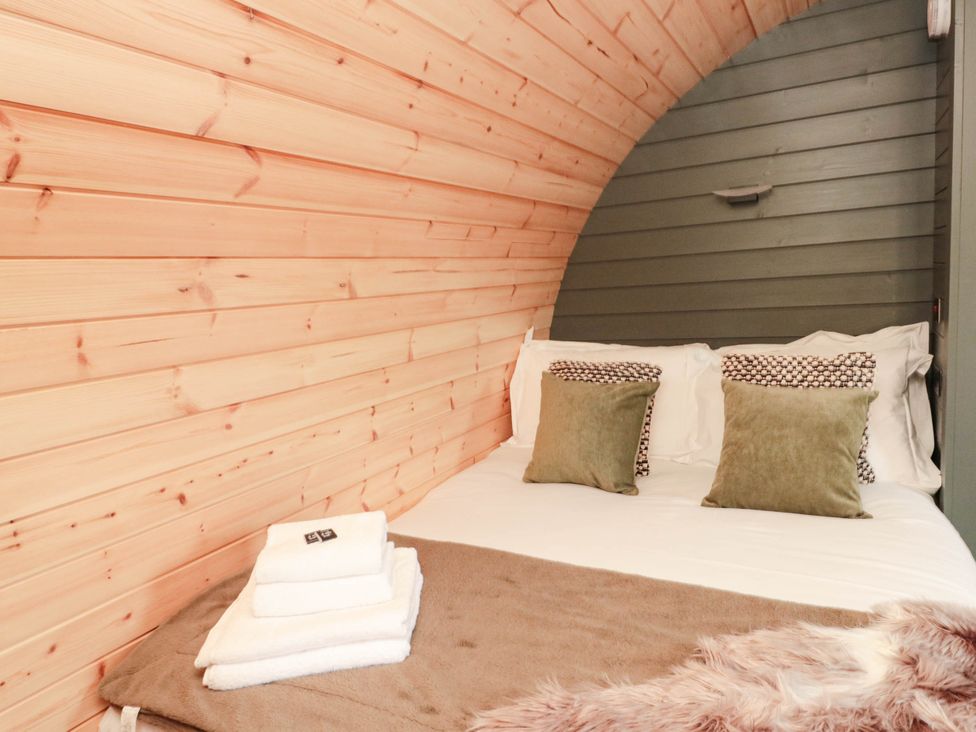 A bedroom with a bed and pillows at Windy Ridge Lodge in Egton