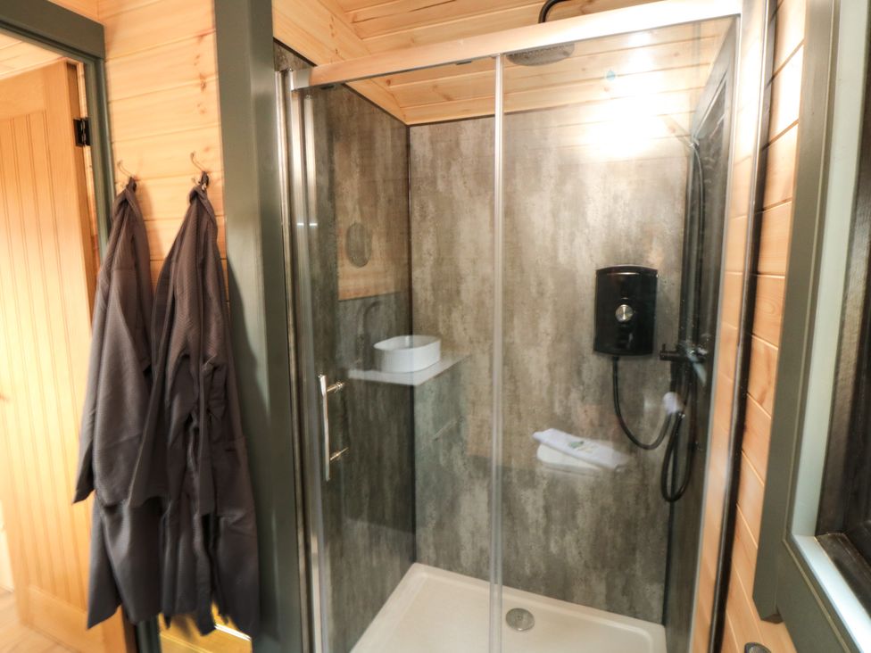 A shower area with towels and robes at Windy Ridge Lodge in Egton