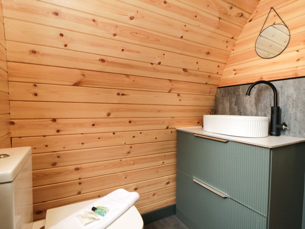 A bathroom with wood paneling and sink at Windy Ridge Lodge in Egton