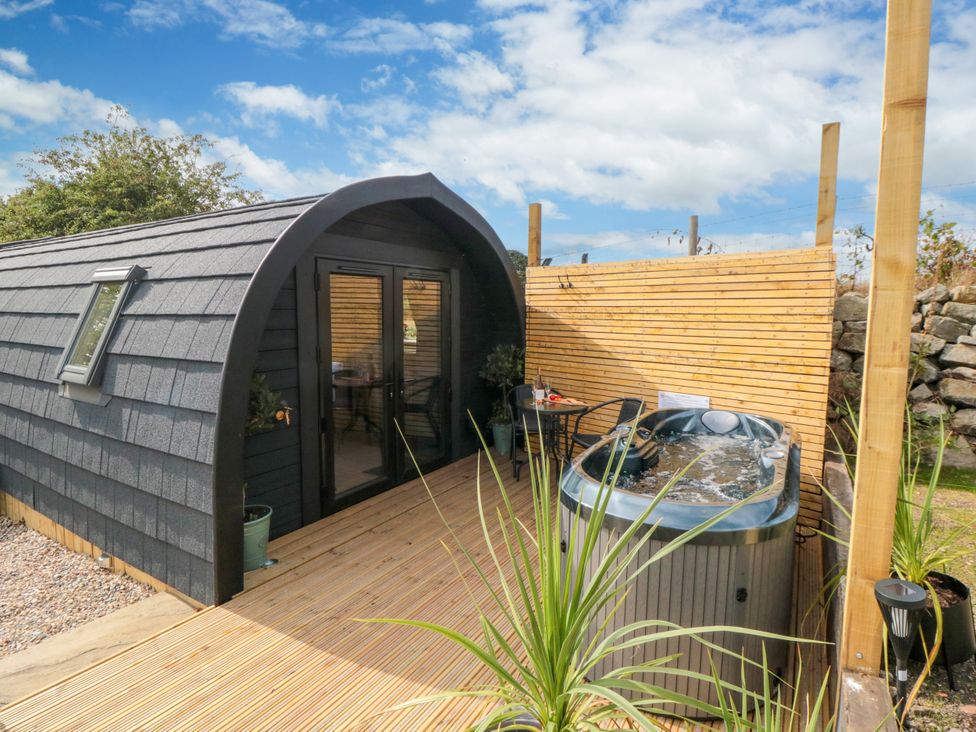 An outdoor area with a hot tub and seating at Windy Ridge Lodge in Egton