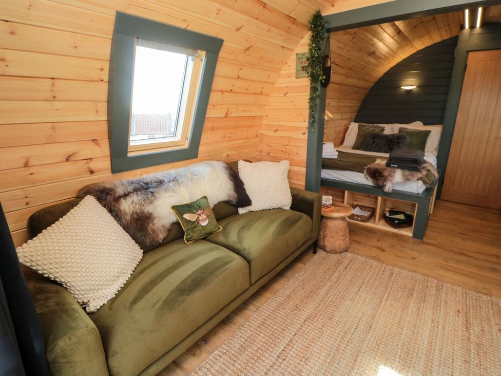 A bedroom with a bed and sofa at Windy Ridge Lodge Egton