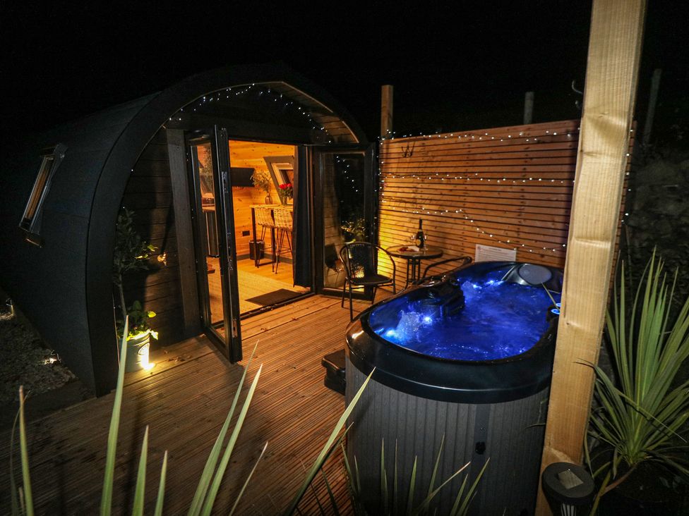 An outdoor area with a hot tub and wooden deck at Windy Ridge Lodge Egton