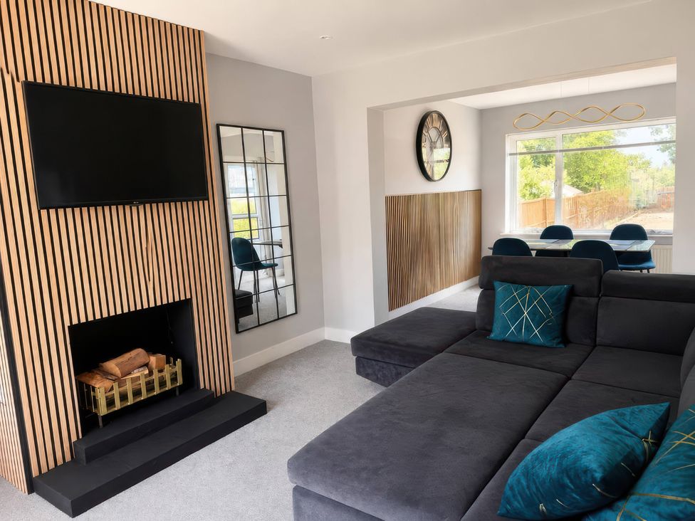 A living room with a television and fireplace at 35 Vivian Gardens Watford