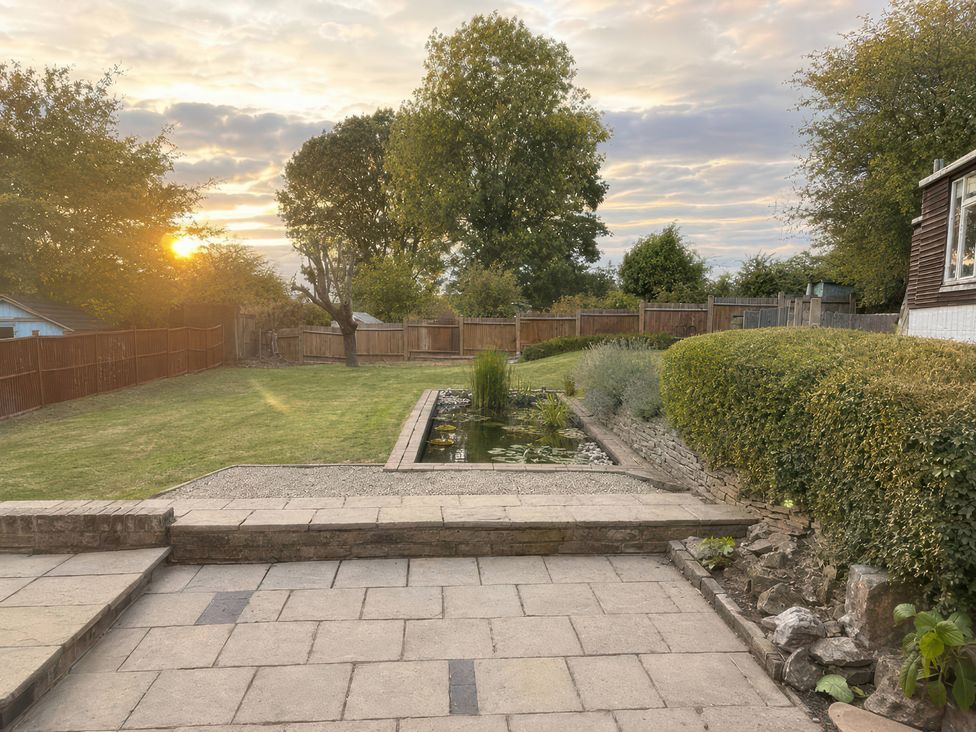 A garden with a pond and grass at 35 Vivian Gardens in Watford