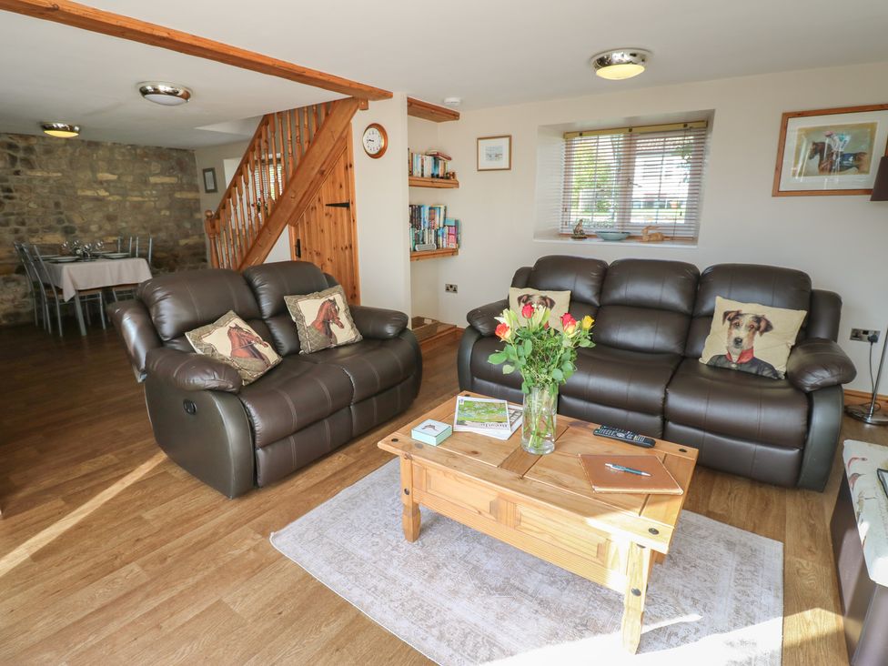 A living room with sofas and a coffee table at Millstone Cottage in Ripon