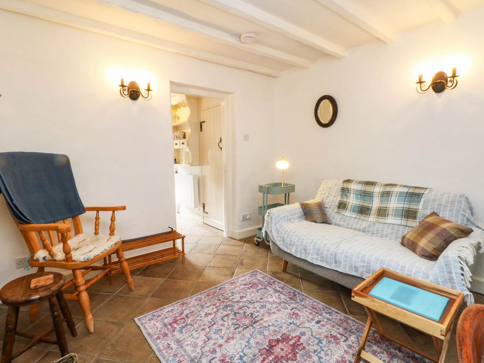A living room with a rocking chair and sofa at 73 Ravensdale Cottages in Cressbrook near Litton, Derbyshire