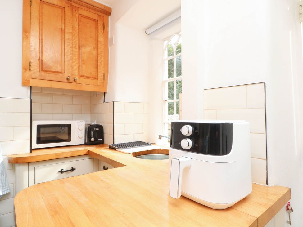 A kitchen with a microwave and an air fryer at 73 Ravensdale Cottages Cressbrook near Litton Derbyshire