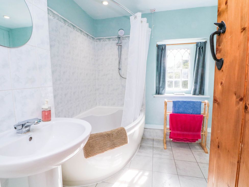 A bathroom with a bathtub and sink at 73 Ravensdale Cottages Cressbrook near Litton Derbyshire