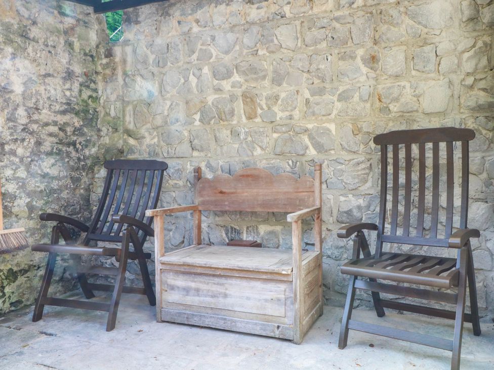 A seating area with two wooden chairs and a storage bench at 73 Ravensdale Cottages, Cressbrook near Litton, Derbyshire