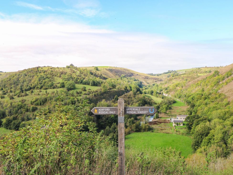 A landscape featuring a signpost with directions in a valley near 73 Ravensdale Cottages, Cressbrook near Litton, Derbyshire