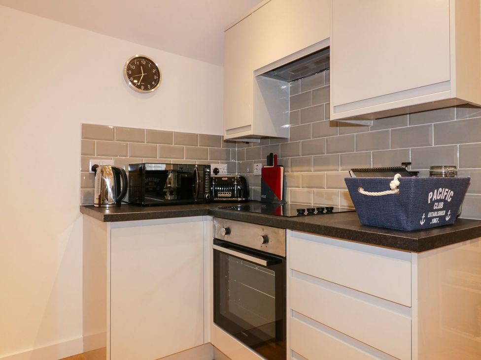 A kitchen with appliances and storage at Fishermans Loft in Mevagissey