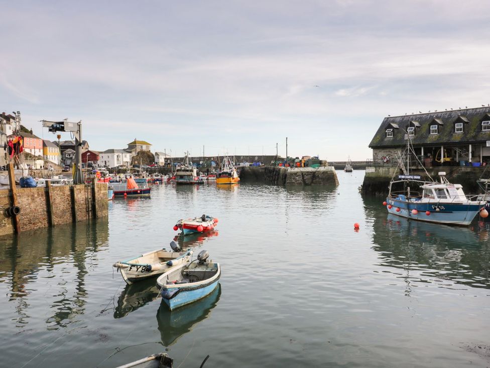 A harbor with boats and fishing equipment at Fishermans Loft in Mevagissey
