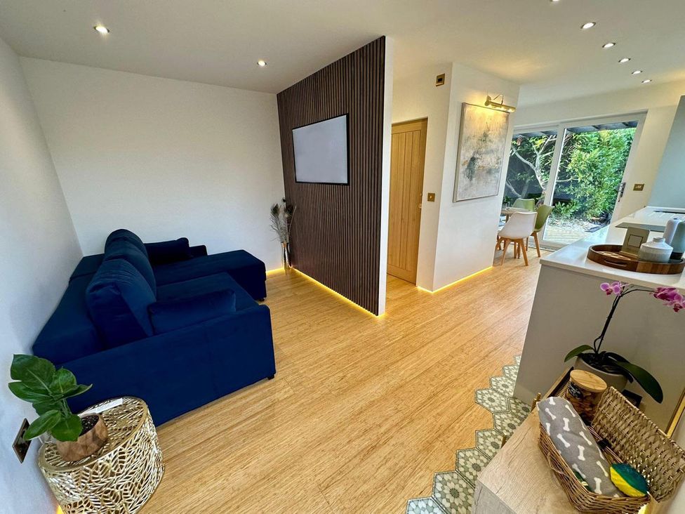 A living room with a sofa and wooden door at Luxurious guest house in Yorkshire with parking, Hemingbrough, Yorkshire