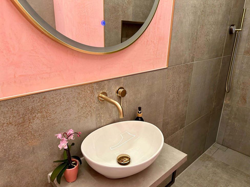 A sink with a mirror and shower in a bathroom at Luxurious guest house in Yorkshire with parking, Hemingbrough, Yorkshire