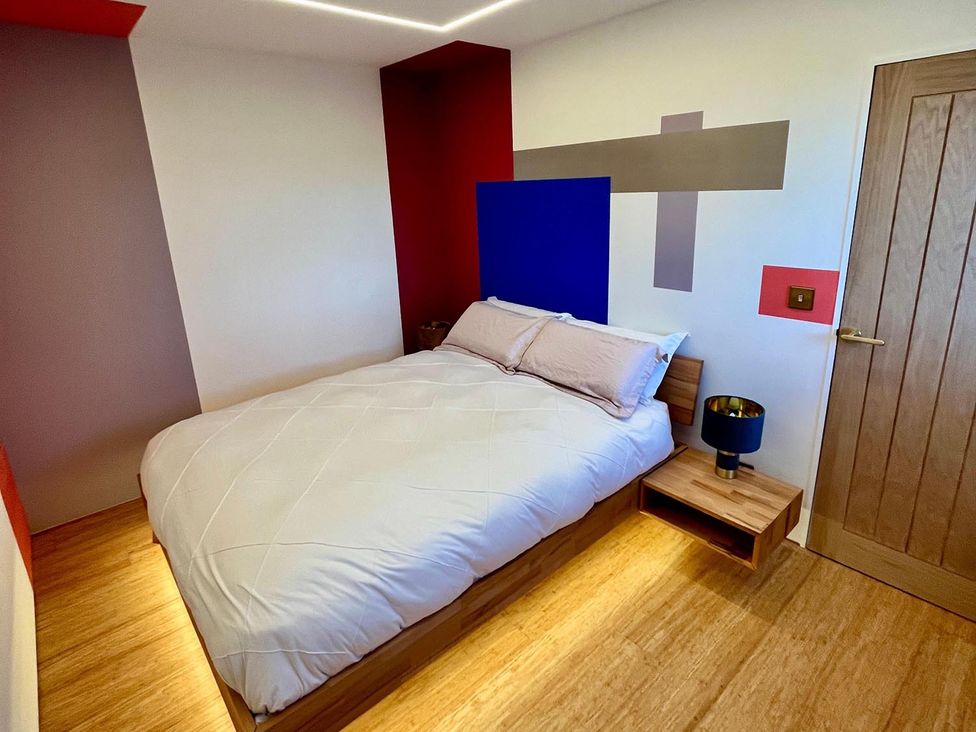 A bedroom with a bed and a bedside table at Luxurious guest house in Yorkshire with parking, Hemingbrough, Yorkshire
