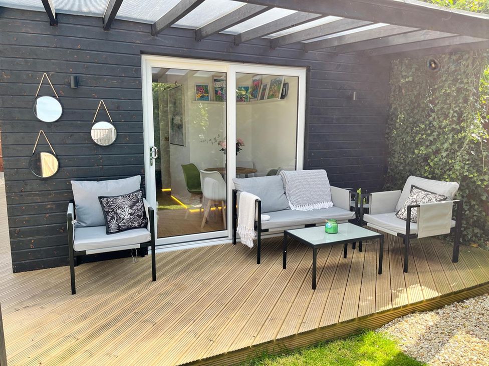 An outdoor seating area with a table and chairs at Luxurious guest house in Yorkshire with parking, Hemingbrough, Yorkshire