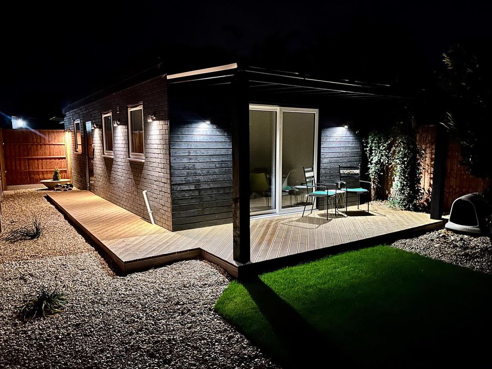 An outdoor area with decking and chairs at Luxurious guest house in Yorkshire with parking, Hemingbrough, Yorkshire