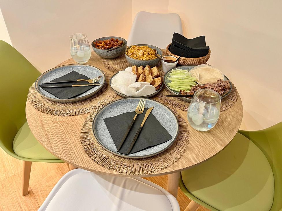 A dining room table set with plates and food bowls at Luxurious guest house in Yorkshire with parking, Hemingbrough, Yorkshire