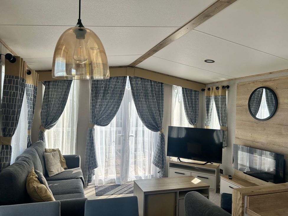 A living room with a sofa and television at The Old Barn in Manchester