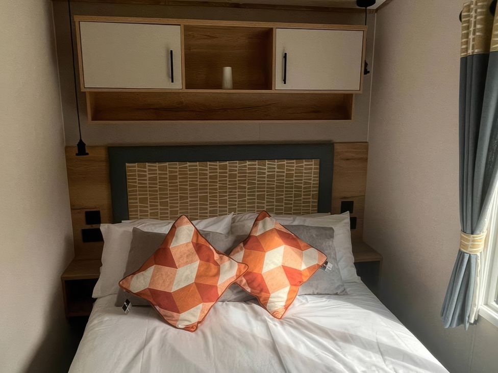 A bedroom with a bed and decorative pillows at The Old Barn in Manchester
