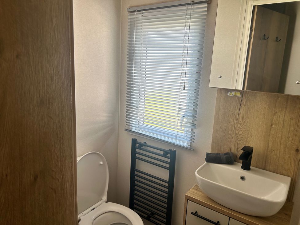 A bathroom with a toilet and sink at the property